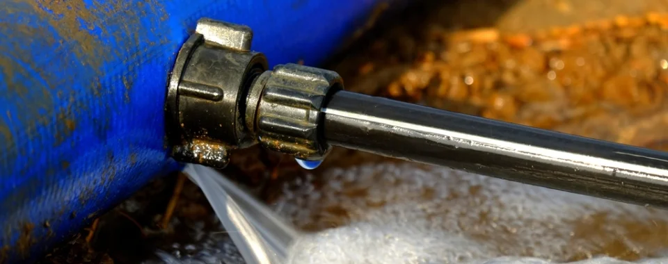 Water spraying from a leaking pipe fitting on a water line